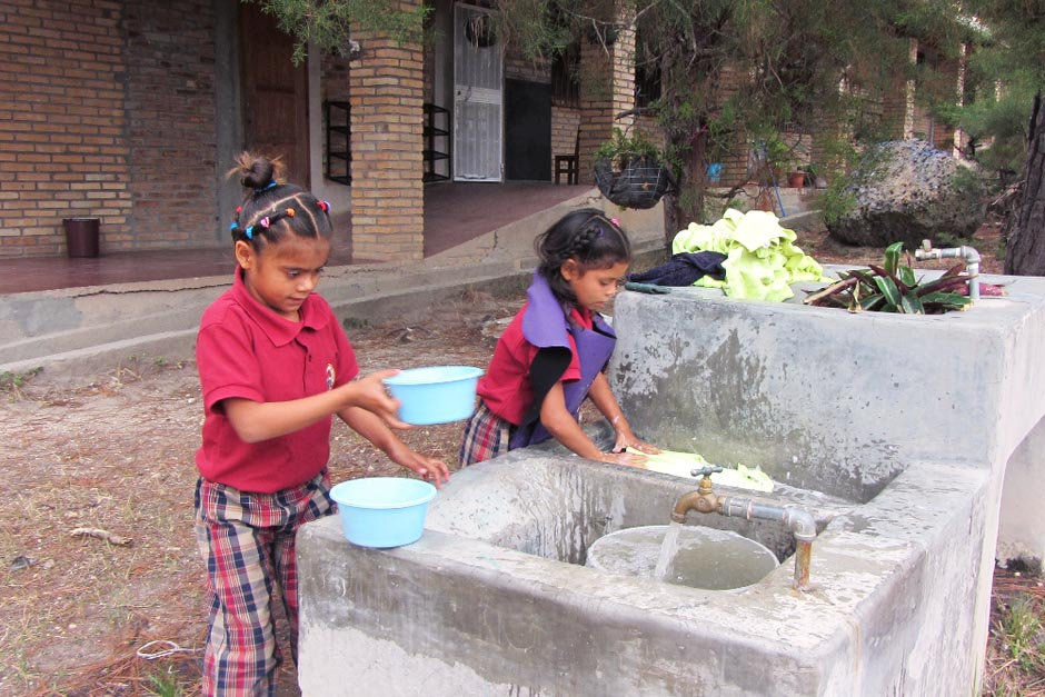 Honduran girls washing veggies